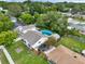 Aerial view of home with a pool, shed, trailer, and mature trees providing privacy at 1305 Willow Valley Dr, Brandon, FL 33510