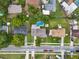 Overhead view of a residential street showcasing well-maintained homes and a kidney-shaped backyard pool at 1305 Willow Valley Dr, Brandon, FL 33510