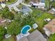 Aerial view of a home featuring a kidney-shaped pool surrounded by lush greenery and a small pool house at 1305 Willow Valley Dr, Brandon, FL 33510