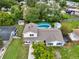 An aerial shot of home shows a pool, shed, large yard, and mature trees around the house at 1305 Willow Valley Dr, Brandon, FL 33510