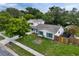 An aerial view of a well maintained home featuring a green lawn, blue shutters, and a cozy fenced backyard at 1305 Willow Valley Dr, Brandon, FL 33510