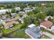 Aerial view of a residential neighborhood with green lawns and mature trees, showcasing a home with a fenced backyard at 1305 Willow Valley Dr, Brandon, FL 33510