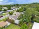 Aerial view of a home featuring a fenced backyard with lush greenery and a shed at 1305 Willow Valley Dr, Brandon, FL 33510