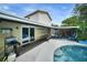 Inviting backyard with pool, covered patio, and outdoor seating area at 1305 Willow Valley Dr, Brandon, FL 33510