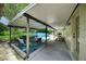 Covered backyard patio with seating, dining table, and pool view at 1305 Willow Valley Dr, Brandon, FL 33510