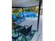 Shaded backyard patio with lounge chairs and view of pool at 1305 Willow Valley Dr, Brandon, FL 33510