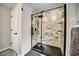 Modern bathroom featuring black framed glass shower with marble look tiles at 1305 Willow Valley Dr, Brandon, FL 33510