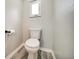 Small lavatory displaying toilet on gray wood look flooring at 1305 Willow Valley Dr, Brandon, FL 33510