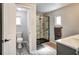 Modern bathroom showcasing a stylish vanity, a glass-enclosed shower with black trim, and wood-look flooring at 1305 Willow Valley Dr, Brandon, FL 33510