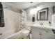 Clean bathroom with a shower-tub combo and gray vanity at 1305 Willow Valley Dr, Brandon, FL 33510