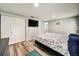 Bedroom featuring hardwood floors, a closet, and a mounted television at 1305 Willow Valley Dr, Brandon, FL 33510