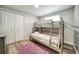 Bedroom with a bunk bed and cozy purple rug at 1305 Willow Valley Dr, Brandon, FL 33510