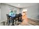 Dining area features modern floors, table with seating, and an open view of the kitchen and backyard at 1305 Willow Valley Dr, Brandon, FL 33510
