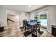 Dining area with seating for six offers backyard views and access to a modern staircase at 1305 Willow Valley Dr, Brandon, FL 33510