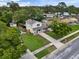 Charming two-story home with a well-manicured lawn, a front porch, and mature trees at 1305 Willow Valley Dr, Brandon, FL 33510