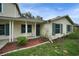 Inviting home exterior features a brick facade, blue shutters, and a neatly landscaped garden at 1305 Willow Valley Dr, Brandon, FL 33510