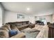 Bright open living room showcases modern floors, a large sectional couch, and dining area with sliding door at 1305 Willow Valley Dr, Brandon, FL 33510