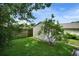 A charming shed sits on a green lawn, providing storage or a potential workspace at 1305 Willow Valley Dr, Brandon, FL 33510