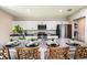 Beautiful kitchen island with stainless steel appliances and four bar stool chairs at 13050 Wellspring Dr, Lithia, FL 33547