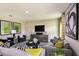 Comfortable living room with contemporary decor, large windows, and neutral color palette at 13050 Wellspring Dr, Lithia, FL 33547