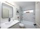 Well-lit bathroom with a tub-shower combo, tiled walls, and modern fixtures at 13203 Royal George Ave, Odessa, FL 33556
