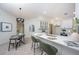 Stylish kitchen with island, modern pendant lighting, and adjacent dining area for entertaining at 13203 Royal George Ave, Odessa, FL 33556