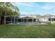 Screened in pool and patio offers a private outdoor oasis with lush green surroundings at 13203 Royal George Ave, Odessa, FL 33556