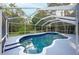 Sparkling screened-in pool with a spa, perfect for relaxation and outdoor enjoyment at 13203 Royal George Ave, Odessa, FL 33556