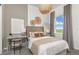 Cozy bedroom with a neutral color scheme, decorative wall art, and a side desk with chair at 13644 Canyon Ridge Rd, Spring Hill, FL 34610