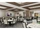 Comfortable dining area with tastefully decorated tables, chairs, and a TV to enhance the eating experience at 13644 Canyon Ridge Rd, Spring Hill, FL 34610