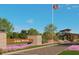 Welcoming entrance to Del Webb River Reserve, with lush landscaping, a modern guardhouse, and an American flag at 13644 Canyon Ridge Rd, Spring Hill, FL 34610