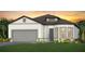 Beautiful single-story home with a gray two-car garage, well-manicured lawn and mature landscaping at 13644 Canyon Ridge Rd, Spring Hill, FL 34610