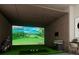 Experience a realistic game on the golf simulator, complete with artificial turf and comfortable seating at 13644 Canyon Ridge Rd, Spring Hill, FL 34610