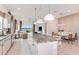 Modern kitchen boasts a large island, white cabinets, stainless steel appliances and an adjacent dining nook at 13644 Canyon Ridge Rd, Spring Hill, FL 34610