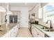 Elegant kitchen featuring light-colored cabinetry, stainless steel appliances, and spacious countertops at 13644 Canyon Ridge Rd, Spring Hill, FL 34610