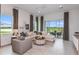 Comfortable living room with a sectional sofa, large windows, and sliding doors to the outdoor patio at 13644 Canyon Ridge Rd, Spring Hill, FL 34610
