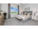 Serene bedroom with a large window, neutral decor, accent wall, and stylish furnishings at 13644 Canyon Ridge Rd, Spring Hill, FL 34610