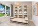 Bright sitting room featuring stylish shelving, a comfortable daybed, and large windows with a scenic view at 13644 Canyon Ridge Rd, Spring Hill, FL 34610