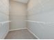 Spacious walk-in closet with multiple levels of wire shelving for optimal storage and organization at 13644 Canyon Ridge Rd, Spring Hill, FL 34610