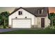Charming two-story home featuring a garage and manicured front lawn with attractive landscaping at 13755 Canyon Ridge Rd, Spring Hill, FL 34610