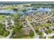 Aerial view of a residential neighborhood featuring houses, lakes, and green spaces at 13830 Trull Way, Hudson, FL 34669