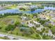 An aerial view of the community pool, tennis courts, and lake at 13830 Trull Way, Hudson, FL 34669