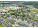 Community aerial view showcases a serene neighborhood with a central lake, lush greenery, and well-maintained streets at 13830 Trull Way, Hudson, FL 34669