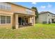 Expansive backyard featuring a cozy covered patio area and manicured grass lawn at 13830 Trull Way, Hudson, FL 34669