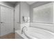 Bright bathroom featuring a soaking tub with a window at 13830 Trull Way, Hudson, FL 34669