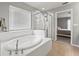 Bathroom featuring a soaking tub and glass shower at 13830 Trull Way, Hudson, FL 34669
