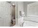 Bright bathroom featuring a soaking tub and toilet behind an open door at 13830 Trull Way, Hudson, FL 34669