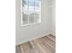 A closet space with wood-style flooring and a window providing natural light at 13830 Trull Way, Hudson, FL 34669