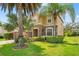 Two-story home featuring stone accents, well-maintained landscaping, and palm trees at 13830 Trull Way, Hudson, FL 34669