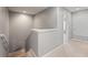 Hallway with carpeted stairs and neutral paint at 13830 Trull Way, Hudson, FL 34669